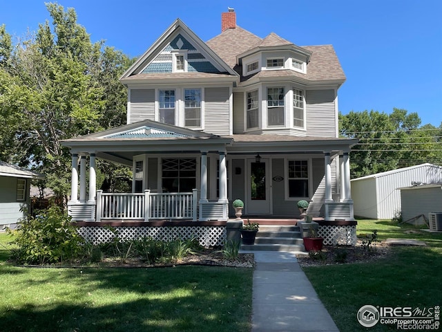 victorian home featuring a front yard and covered porch