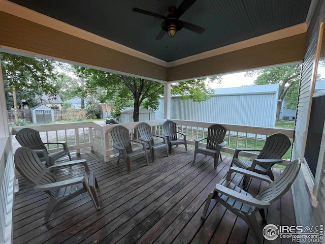 wooden terrace with ceiling fan and a storage unit