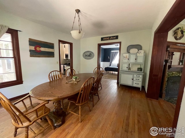 dining space with wood-type flooring