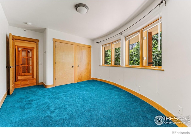 unfurnished bedroom featuring a closet and carpet floors