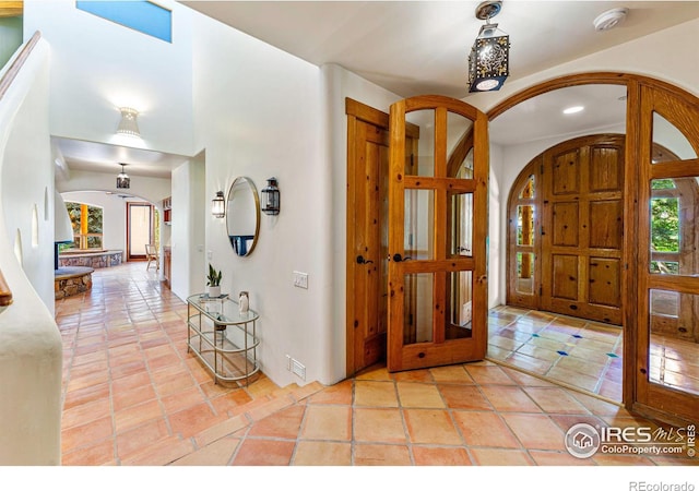 tiled entryway featuring french doors