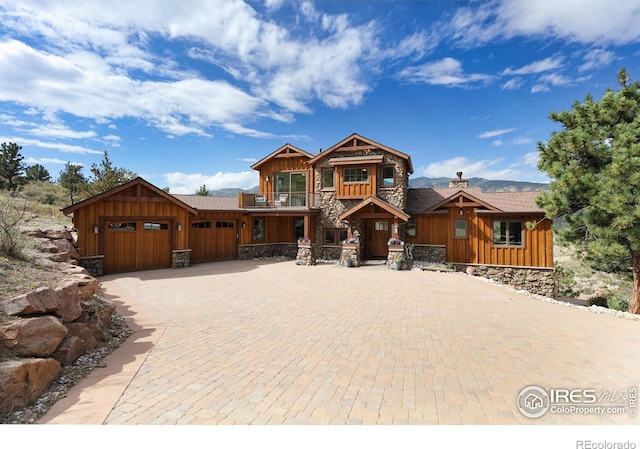 view of front of property featuring a balcony and a garage