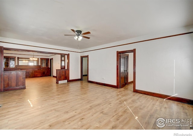 interior space with ceiling fan with notable chandelier and light wood-type flooring