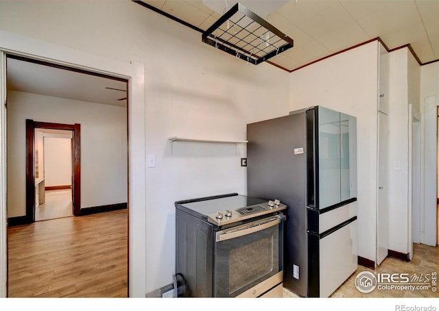 kitchen with appliances with stainless steel finishes and light hardwood / wood-style floors