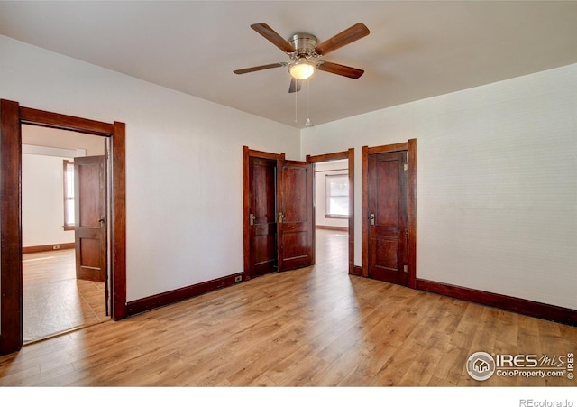 tiled empty room featuring ceiling fan