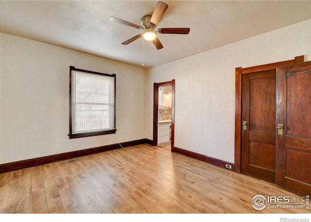 spare room featuring ceiling fan and light wood-type flooring