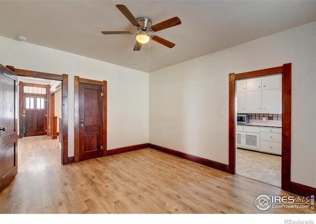 spare room featuring ceiling fan and light wood-type flooring