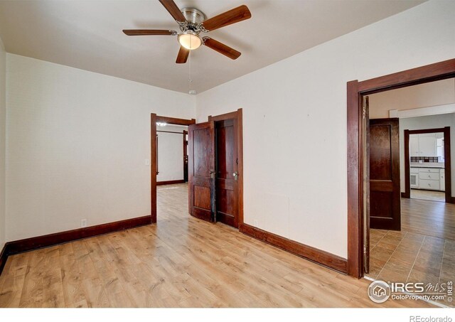 tiled empty room with ceiling fan