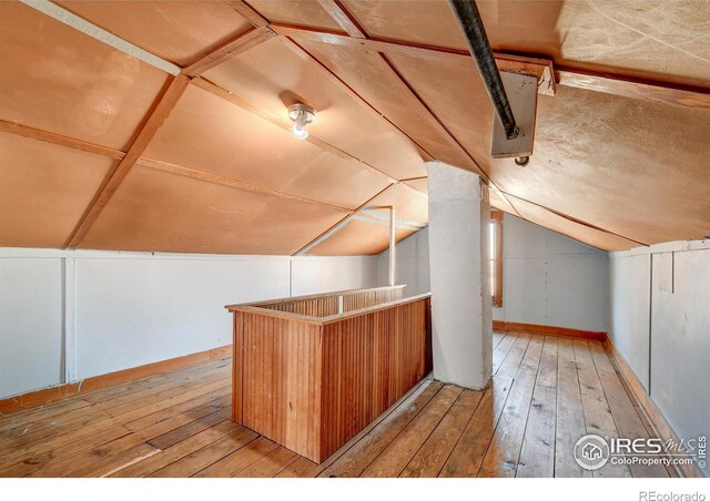 bonus room featuring lofted ceiling and light wood-type flooring