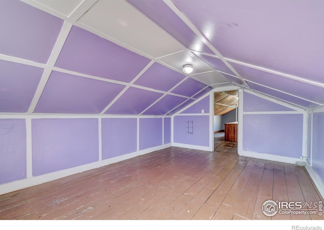 bonus room with vaulted ceiling and hardwood / wood-style flooring