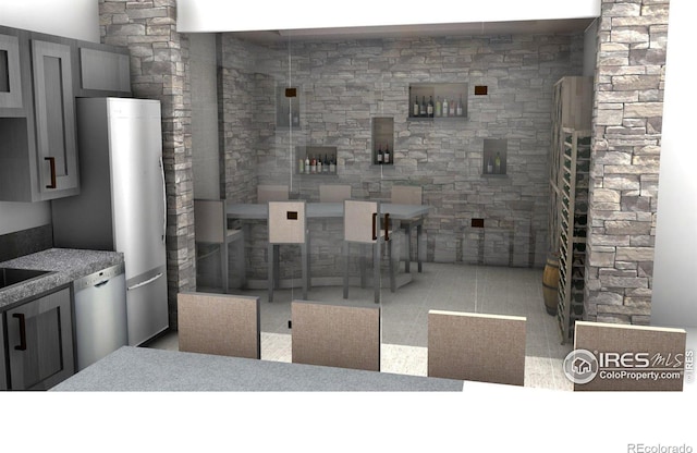 interior space with gray cabinetry, light tile floors, and dishwasher