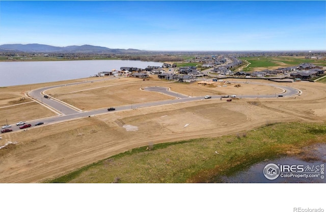 drone / aerial view with a water and mountain view