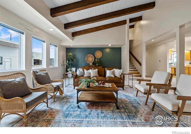 living room featuring lofted ceiling with beams and wooden ceiling