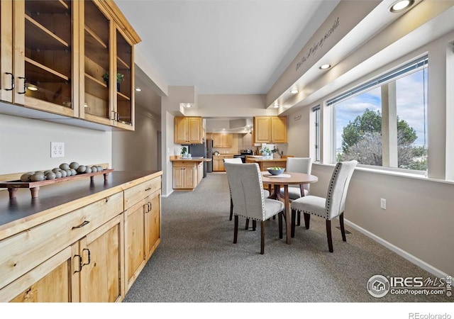 dining space featuring dark colored carpet