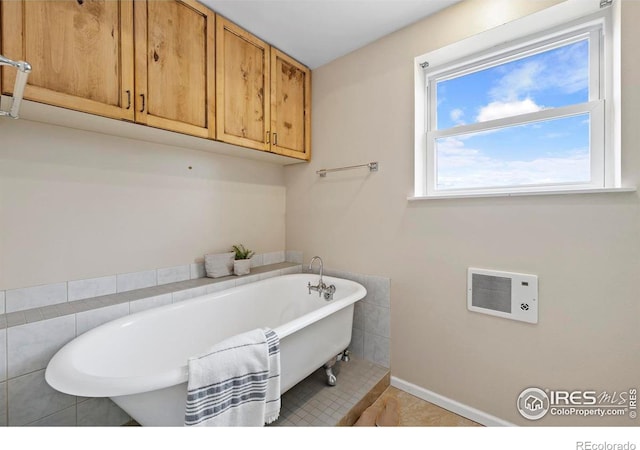 bathroom featuring tile patterned flooring and a tub to relax in