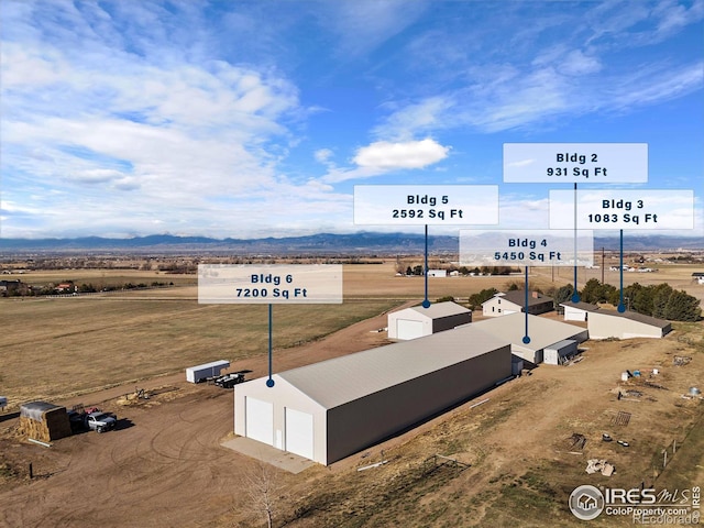 drone / aerial view with a mountain view and a rural view