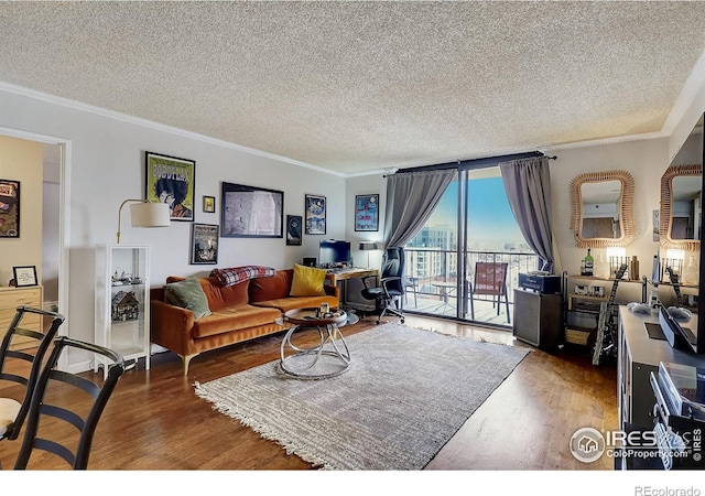 living room with dark hardwood / wood-style floors, a textured ceiling, and ornamental molding