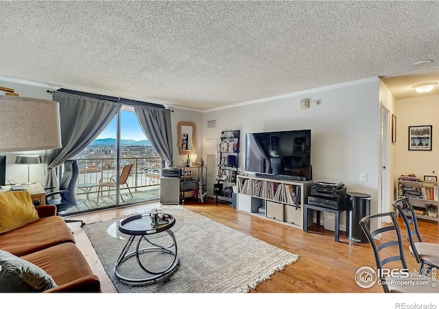 living room featuring ornamental molding, hardwood / wood-style flooring, and a textured ceiling