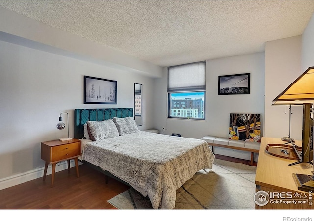 bedroom featuring hardwood / wood-style flooring and a textured ceiling