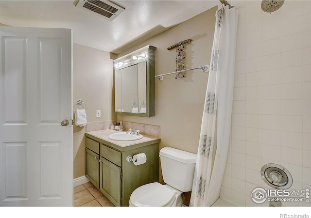 bathroom featuring large vanity, tile floors, and toilet