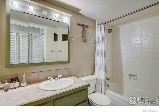 full bathroom with vanity with extensive cabinet space, toilet, and shower / bath combination with curtain