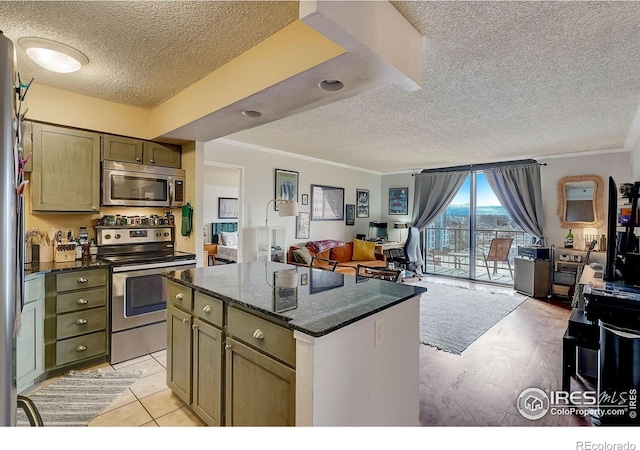 kitchen with a kitchen island, stainless steel appliances, and a textured ceiling