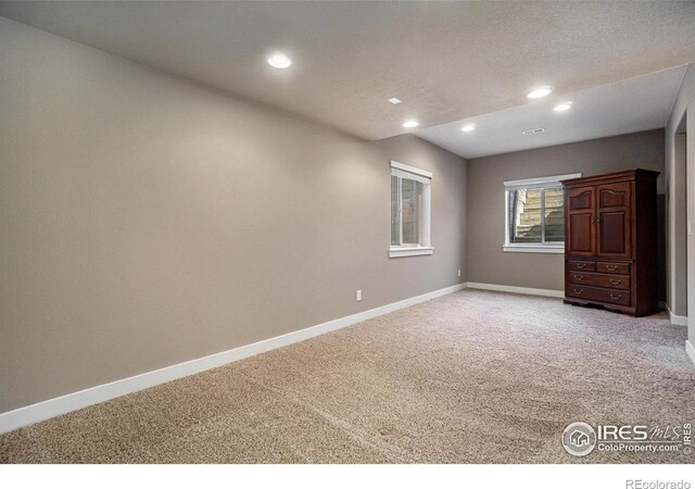 unfurnished room with light colored carpet