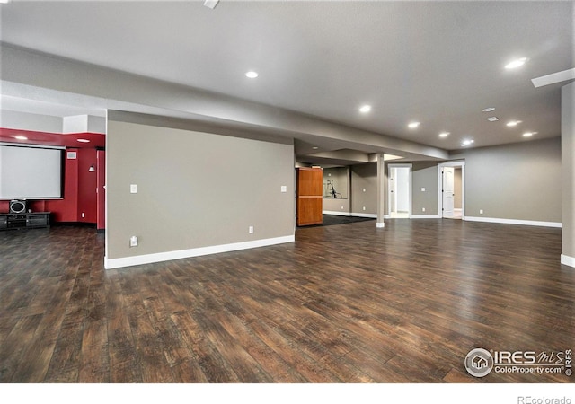 unfurnished living room with dark wood-type flooring