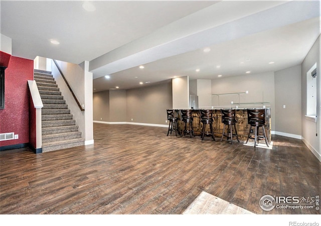 interior space with bar and dark hardwood / wood-style flooring