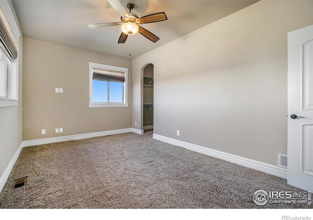 spare room featuring carpet floors and ceiling fan