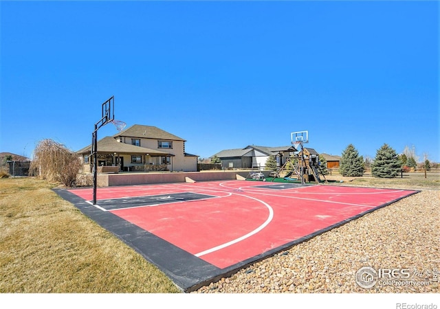 view of basketball court featuring a yard