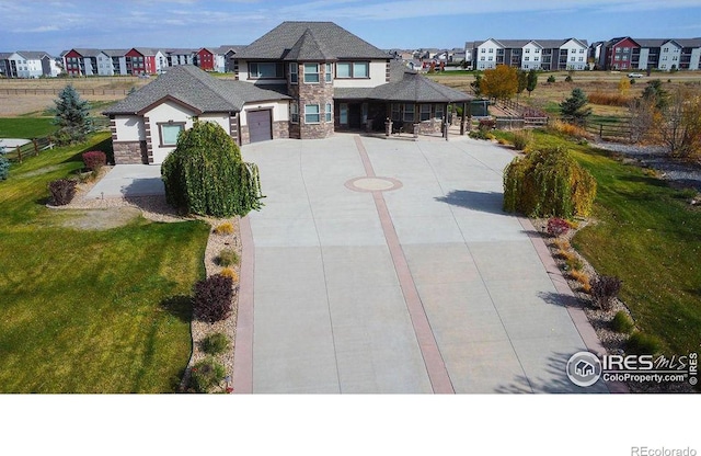 view of front of home featuring a front lawn and a garage