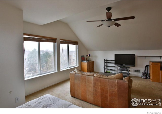 living room with lofted ceiling, light carpet, and ceiling fan