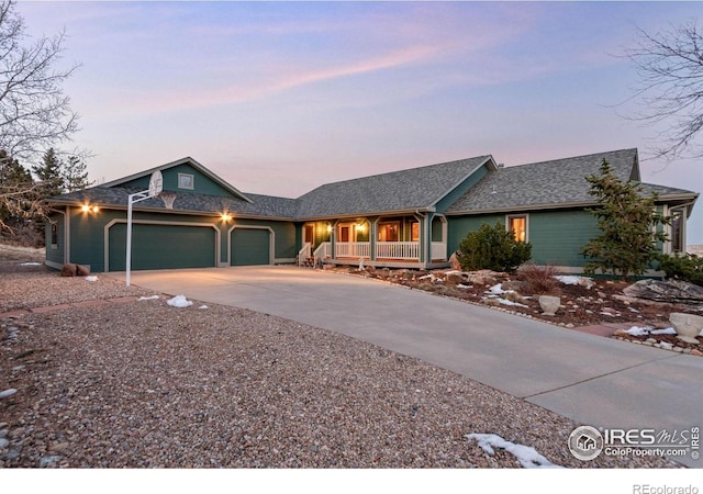 single story home featuring a garage and a porch