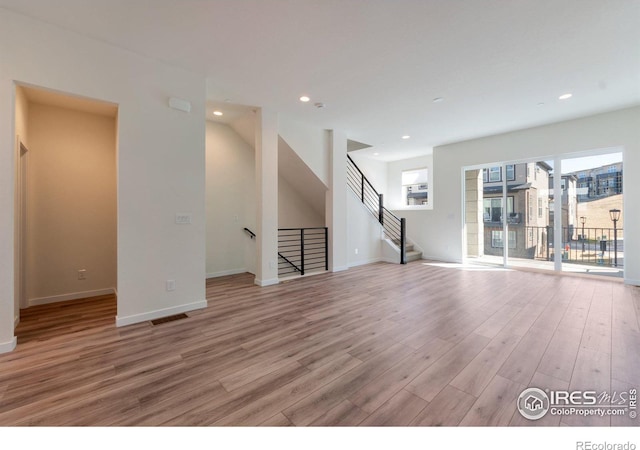 unfurnished living room featuring light wood-type flooring