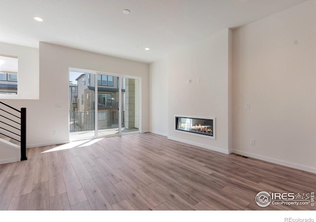 unfurnished living room featuring light hardwood / wood-style flooring