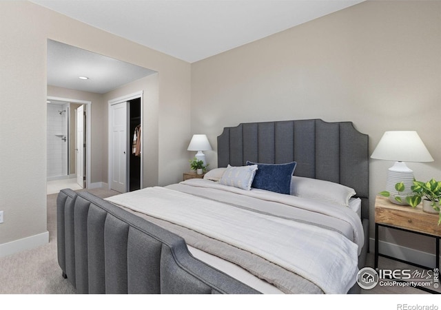 bedroom featuring ensuite bath and light carpet