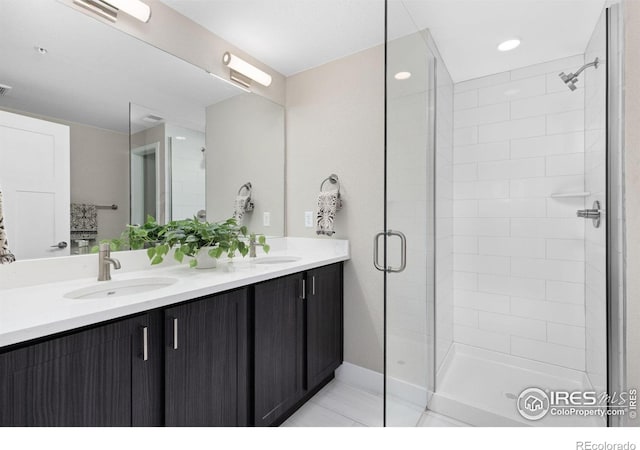 bathroom with vanity and a shower with shower door