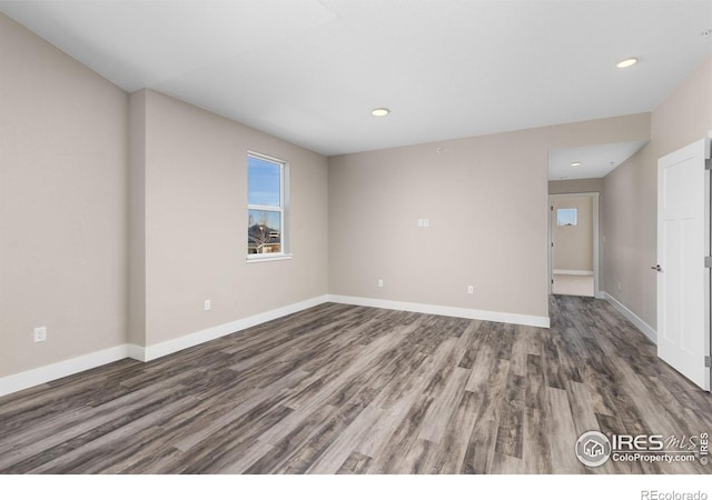 empty room featuring dark hardwood / wood-style flooring