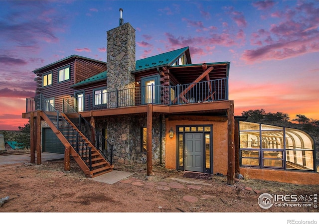 view of back house at dusk