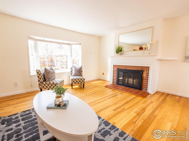 living room with hardwood / wood-style floors and a fireplace