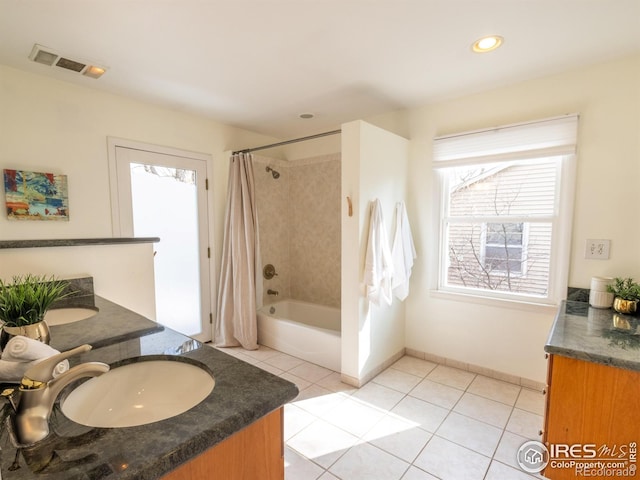 bathroom with tile patterned flooring, shower / tub combo, and vanity