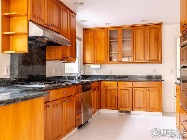 kitchen with dark stone counters, sink, stainless steel dishwasher, light tile patterned floors, and tasteful backsplash