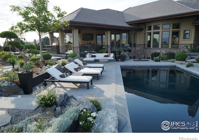 view of pool with a patio and an outdoor hangout area