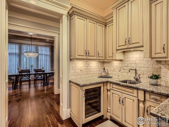 kitchen featuring dark hardwood / wood-style flooring, hanging light fixtures, wine cooler, sink, and crown molding