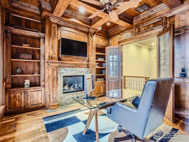 office area with built in shelves, beam ceiling, light hardwood / wood-style flooring, coffered ceiling, and crown molding