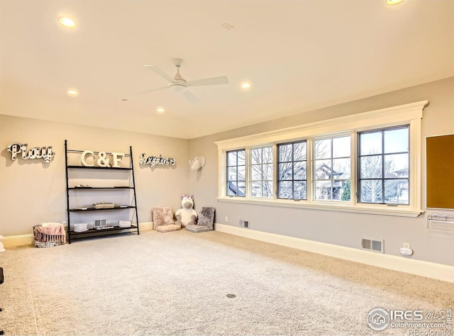 interior space featuring ceiling fan and carpet floors