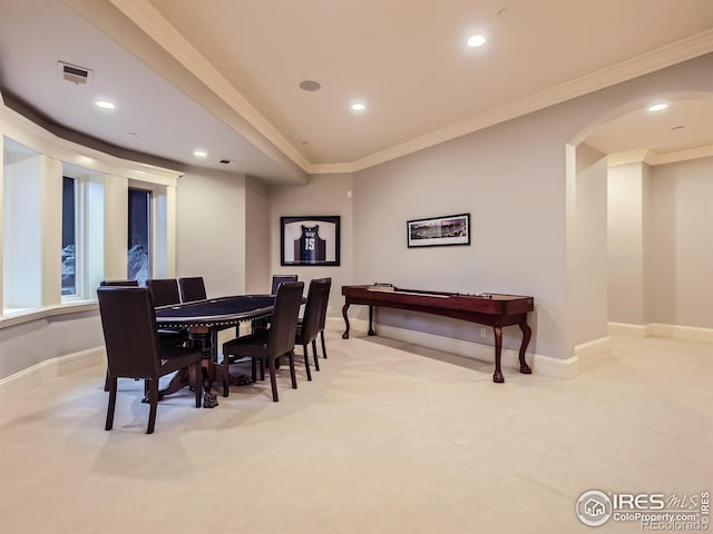 dining room featuring crown molding and light carpet