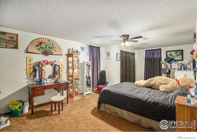 carpeted bedroom with a textured ceiling and ceiling fan