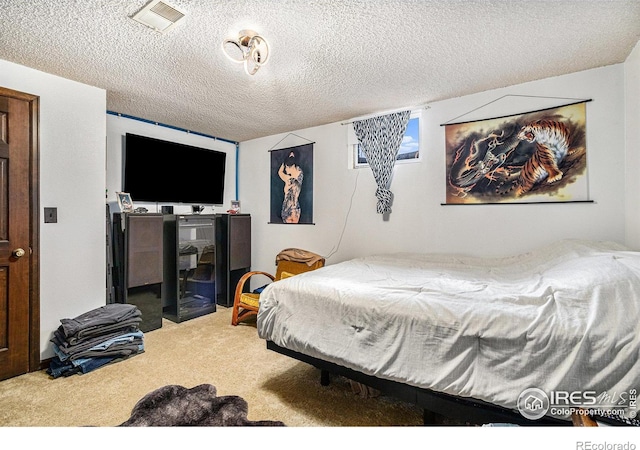 carpeted bedroom featuring a textured ceiling